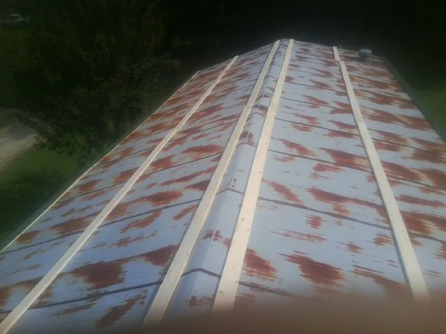 Rusted metal roof panels with new wood purlins before replacement — Storm Damage Roof Repair in Blairstown by Roofing Brothers