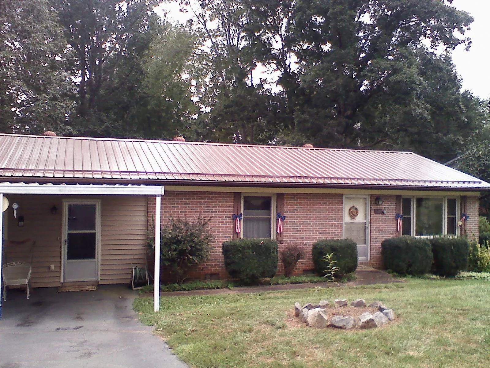 Bronze metal roof and carport on a brick ranch home — Roof Repair work by our crew in Blairstown